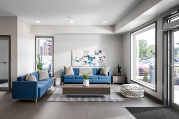 a living room with blue couches and a coffee table
